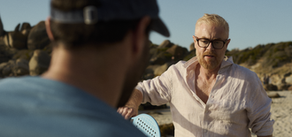 Two men play a game on the beach