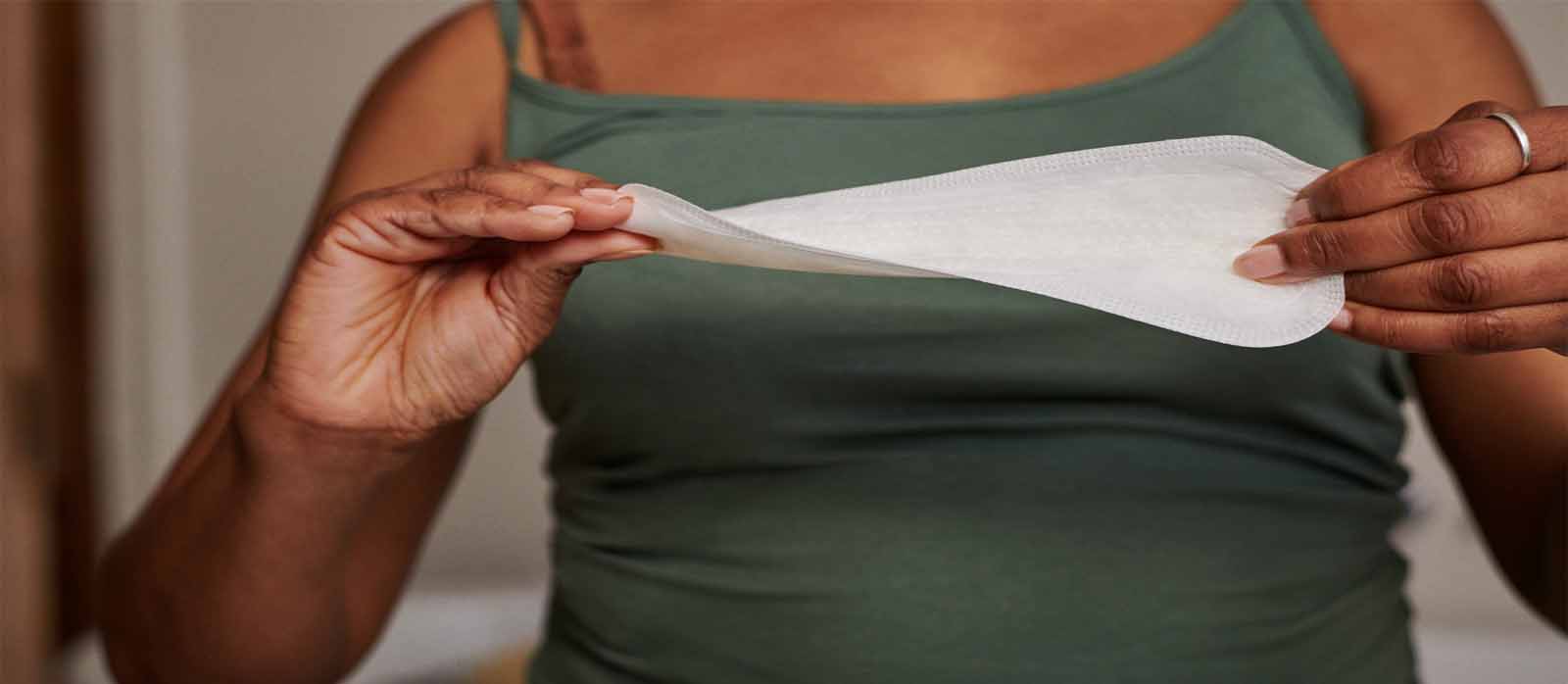 A woman holds up a pad