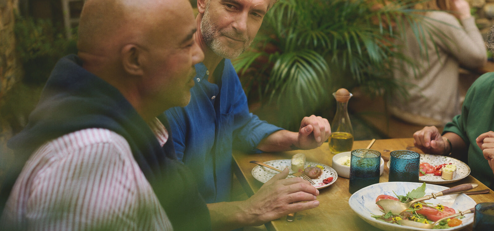 Men talk and enjoy a meal