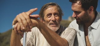 A younger man and older man sit together