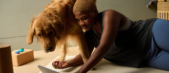 A woman and her dog look at a table