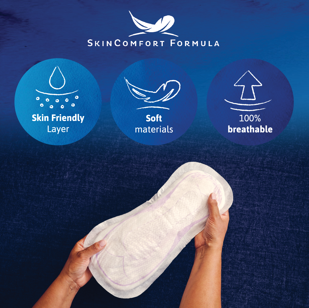 Two hands hold a pad with writing skincomfort formula, skin friendly layer, soft materials, and 100% breathable