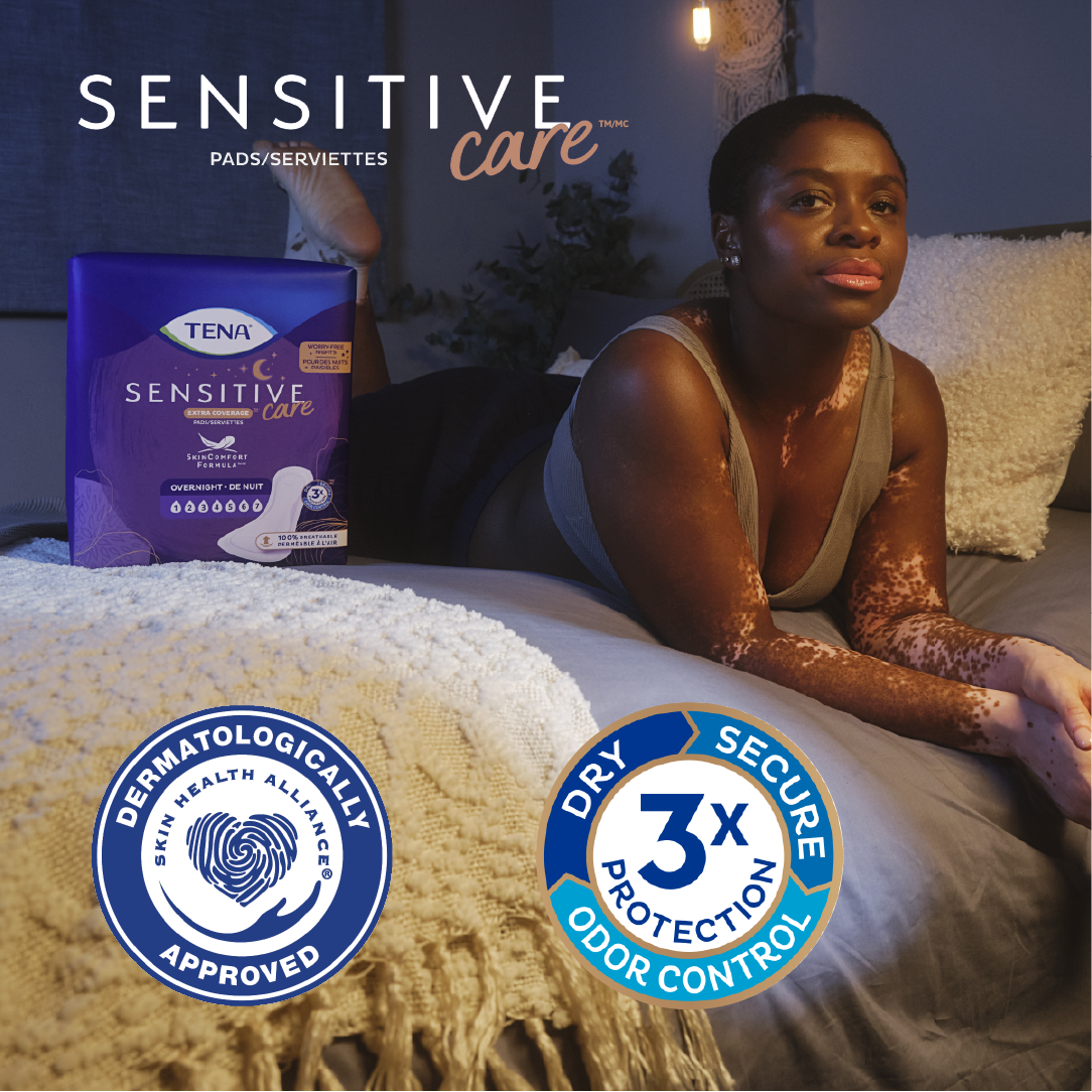 A woman on a bed with writing Sensitive Care pads, dermatologically approved and dry, secure, and odor control